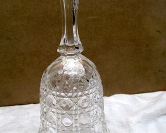 A vintage pressed glass buttons and stars pattern bell.  7" tall 