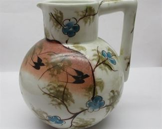 A hand painted old porcelain pitcher.  4.75" tall.   Nick on underside rim of foot not shown in photos