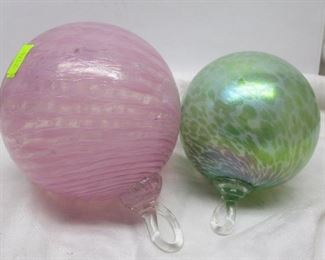 A pink and green mottled art glass ball ornaments.  Largest approximately 4" diameter 
