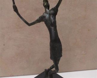 Unsigned, attributed to Danya B, A female tennis player serving sculpture depicts a tennis player in an outstretched pose, ready to serve the ball. Made of bronze or brass.  12" tall including the base