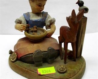 A vintage sculpture of a girl seated next to a fawn and bird with a tray of chicks on her lap.  Unsigned. Origin unknown.  Has composition doll head. Appears to be German.  3 7/8" tall.  CONDITION: Bird on post missing one wing.  One chick missing from tray