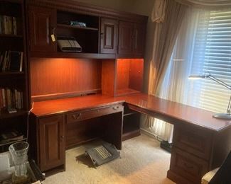 three piece L-shaped executive desk set that includes a bookcase and computer desk