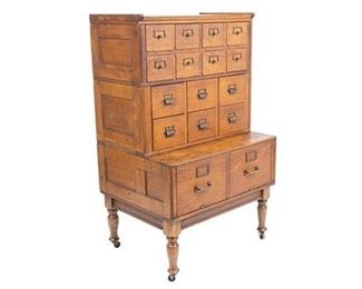 Yawman and Frbe MFG Co. filing cabinet, rustic wooden, metal hardware, 16-drawers, on castors.
54"h x 33"w x 26"d
