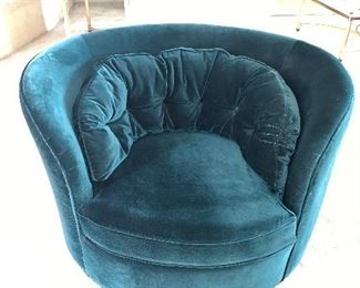 Two curved green velvet rotating living room chairs