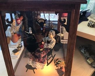 Music Box depicting a grandma resting by a coal stove with many memories of her life surrounding her. Signed by the designer at Small World Designs of Hyattsville, MD.