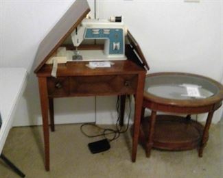 Singer sewing machine in cabinet.