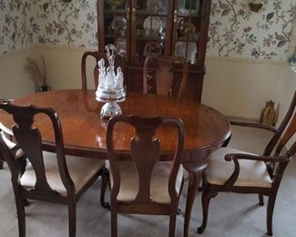 Traditional walnut dining table and chairs with three leaves and pads