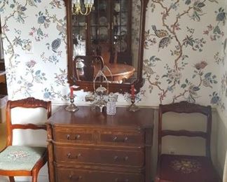 Antique mirrors and needlepoint chairs