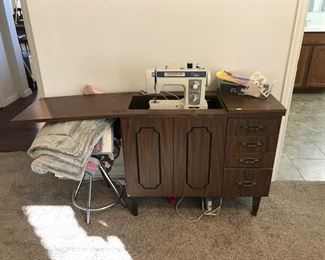 Brother sewing machine and cabinet.  4 drawers filled with treasures included! 