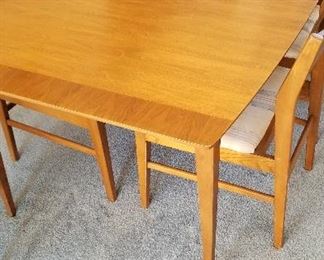 Full view of dining room table.  I think Teak wood.  Measures 40 x 60 plus two 12" leaves and pads.  Perfect top.  Set is $350