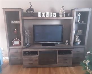 large rustic entertainment center w/fireplace