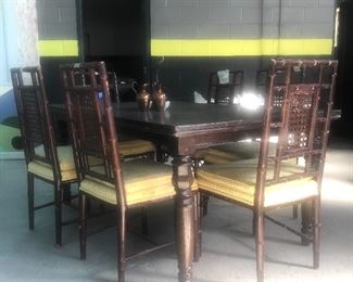 Dining table w minor damage on top corner . Vintage cane back dining chairs from Kornmeyers w wooden bamboo style legs. 