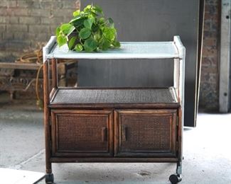 Vintage wicker tea cart, that has been partially painted on casters.