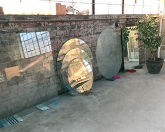 Large assortment of glass and unframed/framed mirrors. 