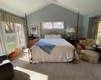 Iron King Size bed, complete.  Floral print chair & ottoman, and more in this master bedroom