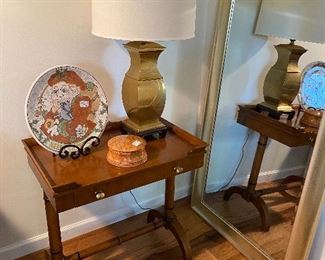 Lamp table with drawer$145.00 , brass lamp $48.00ea. (one of two matching), Rothwoman Christmas Charged$95.00  (signed, dated and numbered on the back), small round burl box $28.00 large mirror leaning on wall $85.00