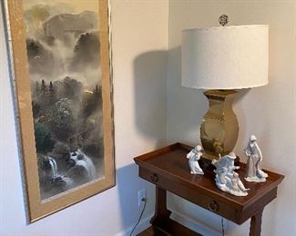 Oriental print framed $225.00, next to Milling Road (Baker Furniture) table $285.00 displaying brass lamp (one of two) $48.00 ea. and Lladro figurines