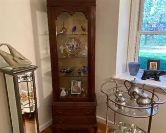Curio cabinet with lower storage $165.00, Pewter finish oval two-tier cart displaying $85.00 pewter tea set $34.00  & goblents