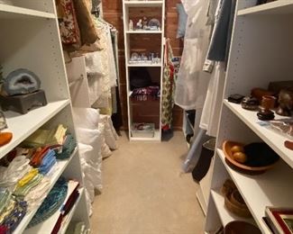 Closet displaying decorative items and linens