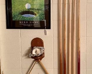 Billiard cues and assorted accessories.