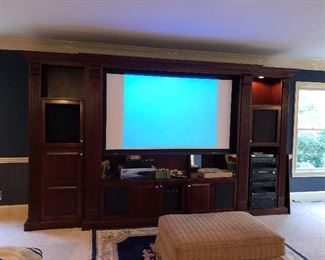 Huge Custom Entertainment Center with built in electric screen the rolls up when televsion is off.  
