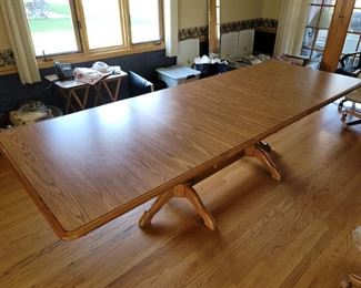 104" long x 42" oak kitchen dining room double pedestal table. 66" x 42" when (4) leafs are taken out. Laminate top to scratches and water stains should never show up like on real wood. 