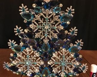 Shades of blue, with clear crystals in snowflake pattern. 
 11" tall.  $485