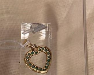 73. $95 - 14kt yellow gold heart with emeralds 