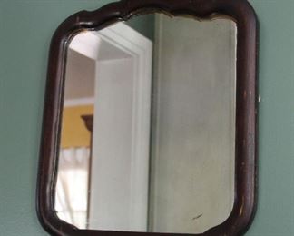 #27. $75.00. Wooden framed mirror dark wood 18” X 16”