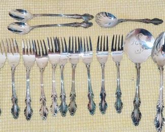 Reed & Barton silverplate English crown
10 forks
2 teaspoons 
One tomato server
1 serving spoon 
1 sugar spoon 
2 ice tea spoons