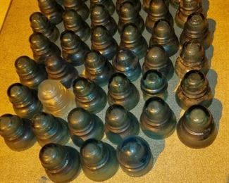 Vintage glass insulator collection, many are deep green glass in color.