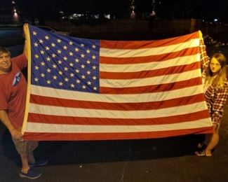 An American flag that is beautiful to hang on a flag pole.