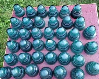 Collection of vintage green glass insulators.