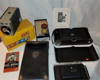 Vintage camera lot including Brownie movie camera, Kodak cameras with original instruction booklets, etc.