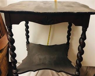 Vintage Side table with rope twist legs. Measures approximately 32 inches in height, and 23 inches in length.