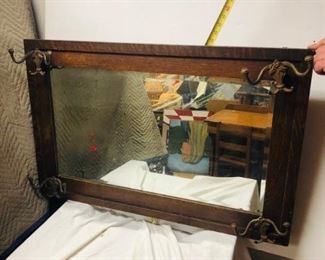 Oak Vintage Hall Mirror.  An early hall mirror with coat hooks. Measures approximately 28 inches in height and 38 inches in length. 