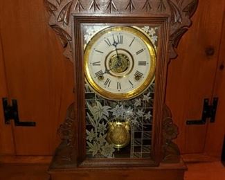 Wim. L. Gilbert Clock Co., Winsted, CT, Trout Gingerbread Clock. Nice carvings with daisies, etched glass, pendulum with leaves, label on back of clock Trout, Wm L. Gilbert, Winsted Conn.