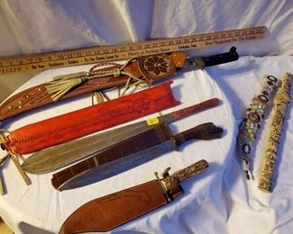 Estate knife collection includes hunting knives with leather sheaths, ornate beaded sheath, One is marked TJI.K.R. 1892 with carved serpent handle. Bowie knife with bone handle, very early wartime Asian knife with all engraved case and Handel, etc. Very nice estate collection of vintage knives.