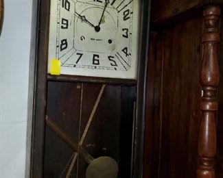 New Haven Clock Co. wall hanging regulator clock with square dial.