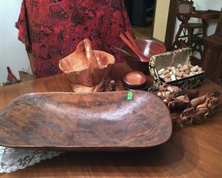 Estate wooden collectibles lot includes vintage wood bowl, carved wooden basket on stand, carved figurnes, folk art carved man and woman, salad bowls, serving fork and spoon with sterling silver tips, carved wooden animal napkin rings, primitive spice chest, etc. (ce) Sat-Lot #87