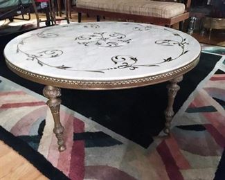 Round decorative marble top coffee table, cut in design on top, brass and marble top.  Measures approx. 36 inches dia. x 17 inches high. (ce) Sat-Lot #107