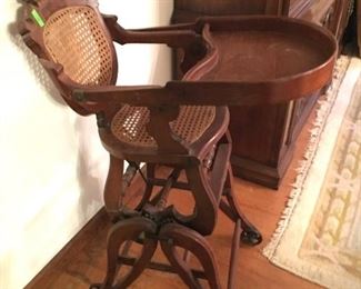 Civil War Era Victorian black walnut up and down high chair. Converts from high chair to carriage or rocker.  Carved and cained back and seat in beautiful condition.  Measures approx. 36 inches tall. (ce) - Sun Lot #78