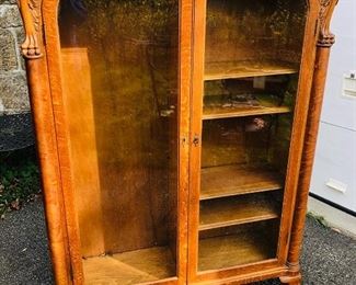 Carved book case or display case, attributed to RJ Horner, lion carved top corners with wings, claw feet, adjustable shelves, 2 glass doors with original key.  Measures approx. 45 inches wide x 62 inches high x 14 inches deep. - Sun Lot #86