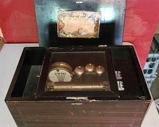 Swiss Orchestra Bell & Drum Cylinder Music Box in all original condition. The box plays nicely. The bells, and drum function. However the drums appear gummed up, and don't strike hard enough to make noise. Needs minor repair on top lid. - Sun Lot #101