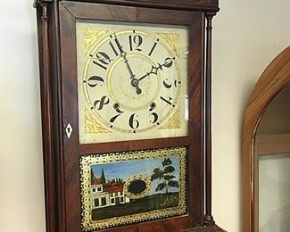Rare Antique Bishop and Bradley Mahogany pillar and scroll clock, Watertown, Connecticut, c. 1825. Scroll top case with turned columns, reverse painted glass tablet, hand painted dial, 3 brass urn finials, wooden works, weight driven, thirty-hour clock. Very nice label, "Made and Sold by Bishop & Bradley, Watertown (Connetcicut). Measures approx. 31 in. tall x 17 in.wide x 4 in. deep. Side label has complete census numbers for 1820(?) U.S., this is a very rare label to find on a pillar and scroll clock! - Sun Lot #129