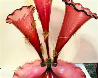 Victorian cranberry glass epergne with applied glass decoration.Has small heat crack on one arm, otherwise in perfect condition, nothing visible.Measures approx. 15 inches tall x 11 inhes wide. - Sun Lot #132