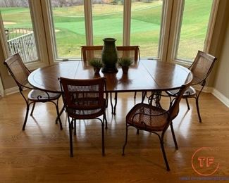 Oval Dining Room Table with Cast Iron Legs and Cane Back Chairs with Cast Iron Arms and Legs