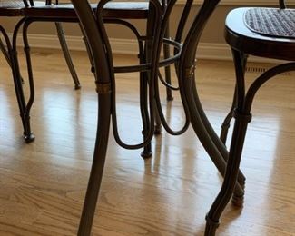 Oval Dining Room Table with Cast Iron Legs and Cane Back Chairs with Cast Iron Arms and Legs