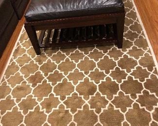 POTTERY BARN AREA RUG, $200. ARAHAUS LEATHER & WOOD OTTOMAN, $275.
