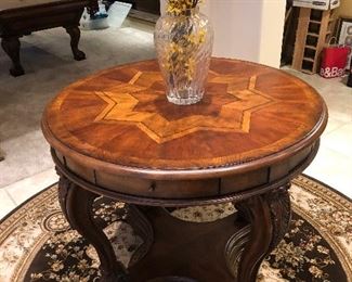 LOVELY INLAID ENTRANCE TABLE, $6OO. BLACK & TAN ROUND AREA RUG, $200.
